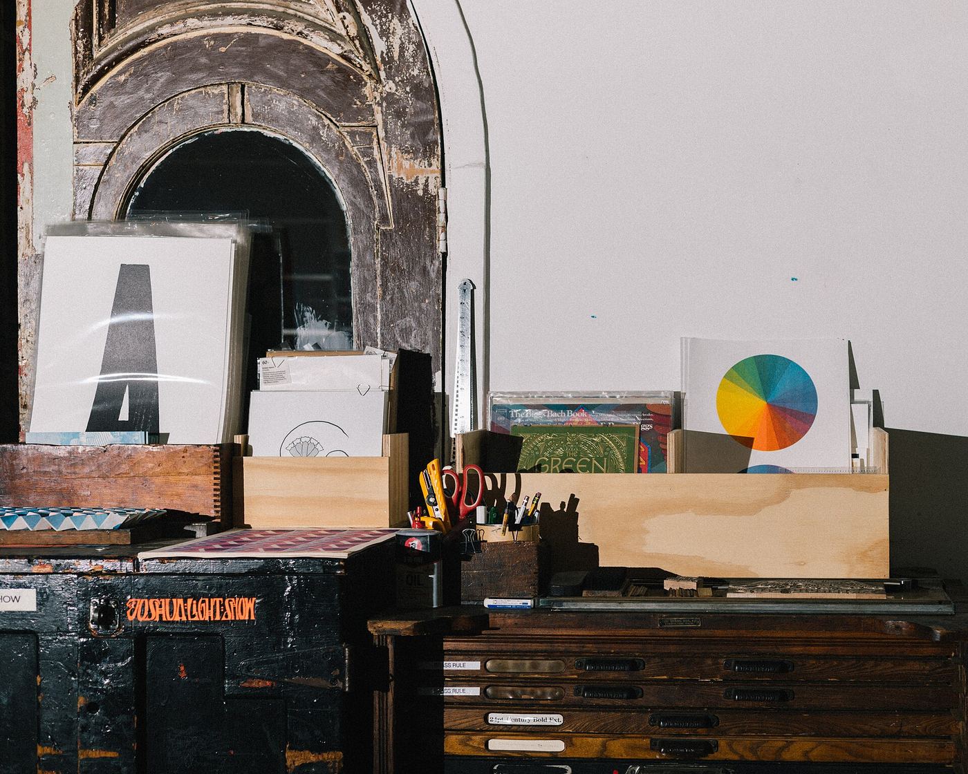 Letterpress counter with paper stock, colour wheel and wooden type cases